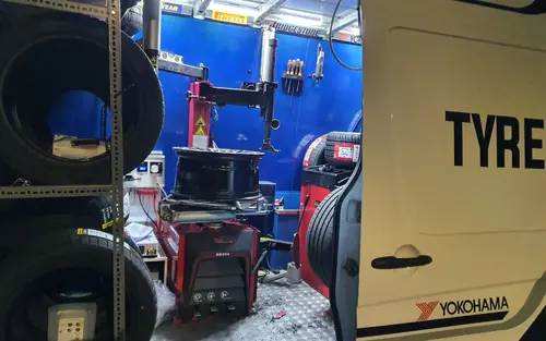Inside one of our vans: tyre changer, wheel balancer and tyres in stock